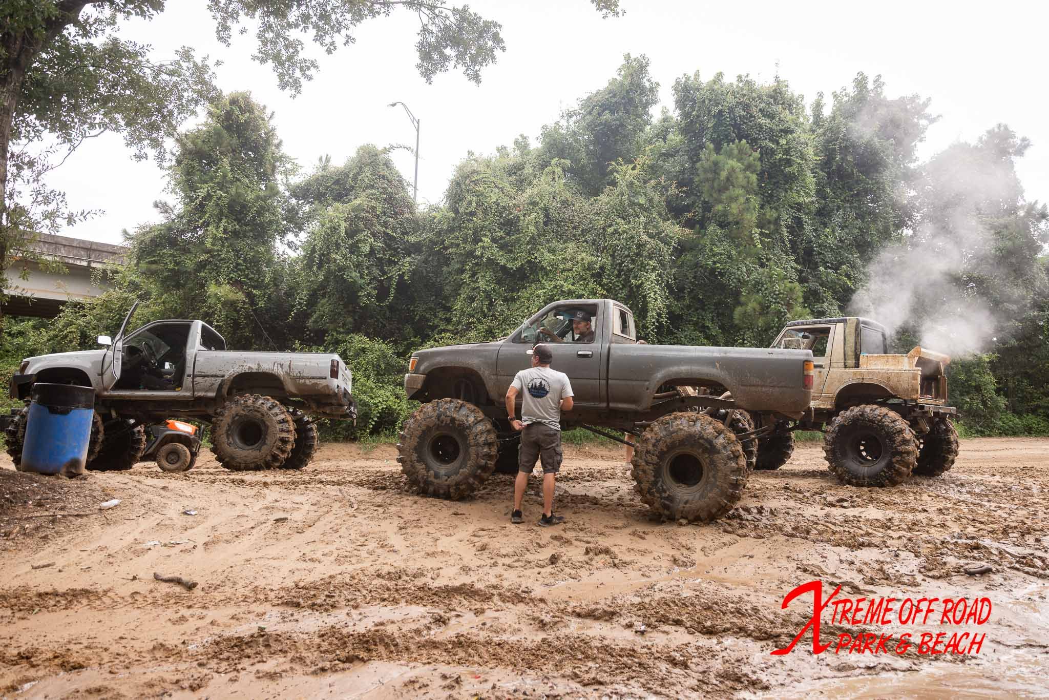 Off-road trucks making their way through the mud at Xtreme Off Road Park