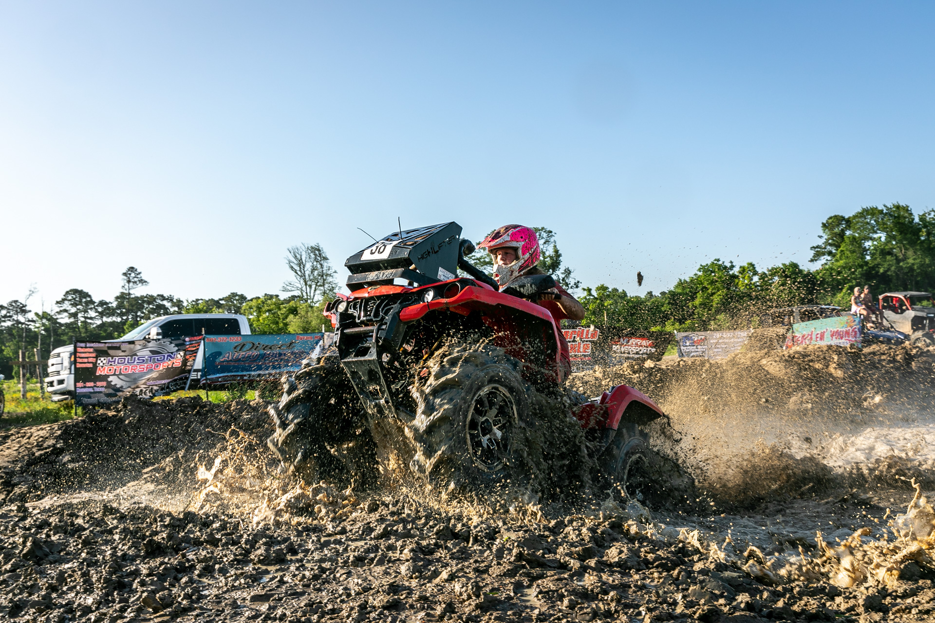 ATV rider powering through a water crossing at Xtreme Unlimited Routes